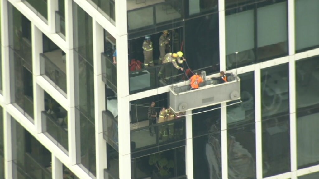 Workers rescued after being stuck in strong winds outside Melbourne CBD ...