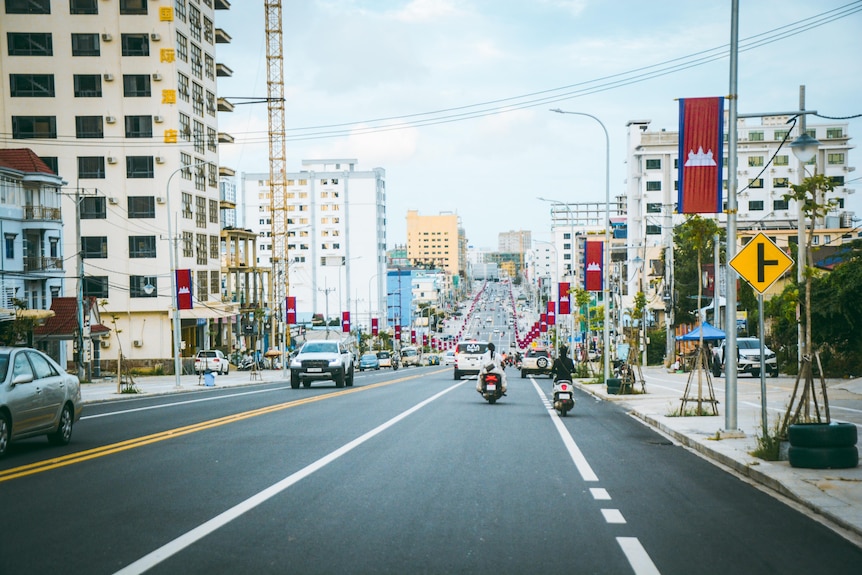 A view of the road with Cambodian flags along the street