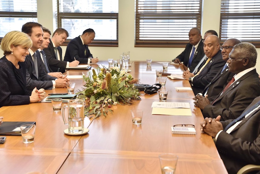 Foreign Affairs Minister Julie Bishop sitting down at a meeting with Solomons Prime Minister Manasseh Sogavare and others.