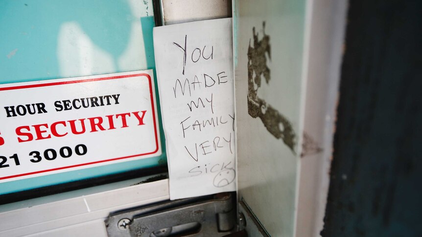 A handwritten note left at the Box Village Bakery reads "you made my family very sick".