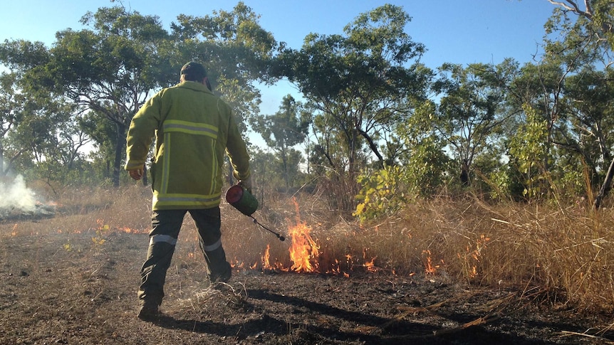 Steele Davies from Bushfires NT lights up along the Stuart Highway, north of Katherine in the Northern Territory.