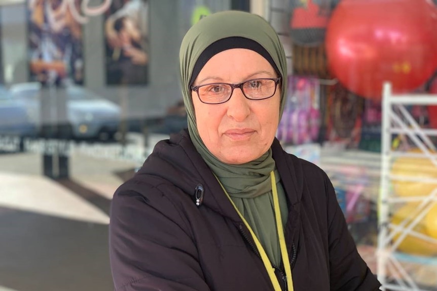 A woman wearing a green headscarf and black jacket in Roxburgh Park.