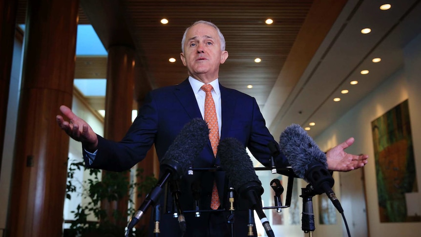 Malcolm Turnbull spreads his arms wide as he speaks to press at Parliament House, Canberra.