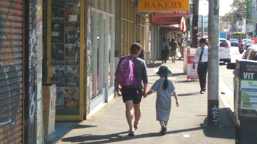 A man walks a girl to school