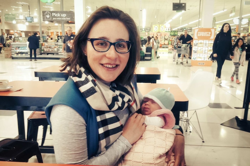 Sarah Scopelianos holding her baby daughter