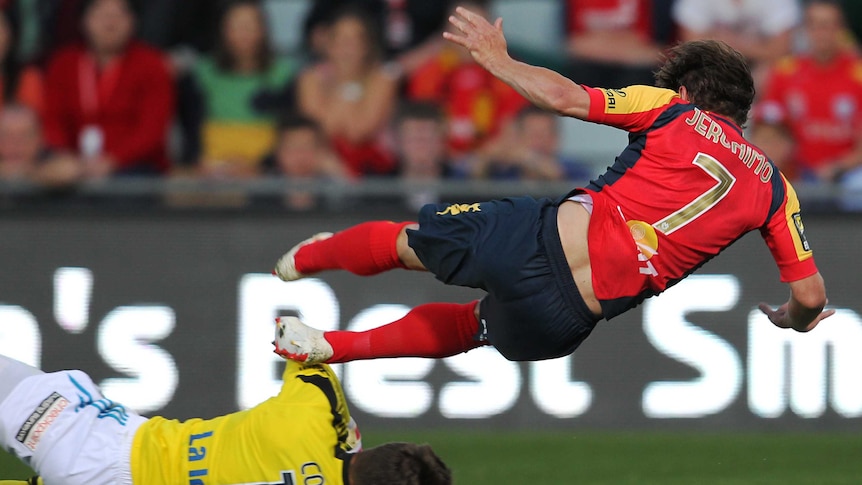 Moment of controversy ... Adelaide's Jeronimo is taken down by Victory goalkeeper Nathan Coe