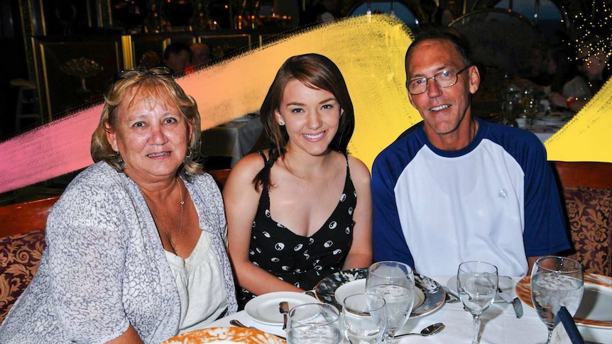 Bridget Murphy sits between her dad and mum at a restaurant table, for a story about what it's like being a young carer.