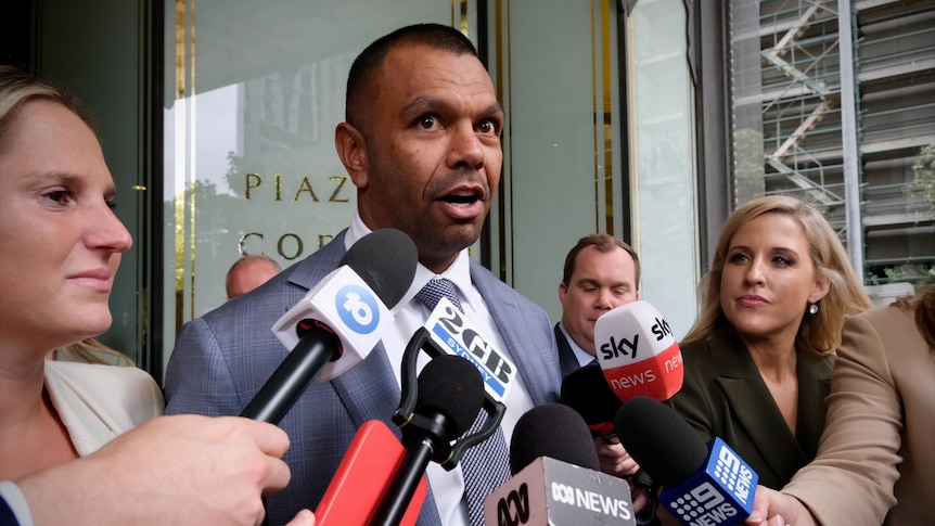 Kurtley Beale dressed in a suit and addresses the media after the verdict