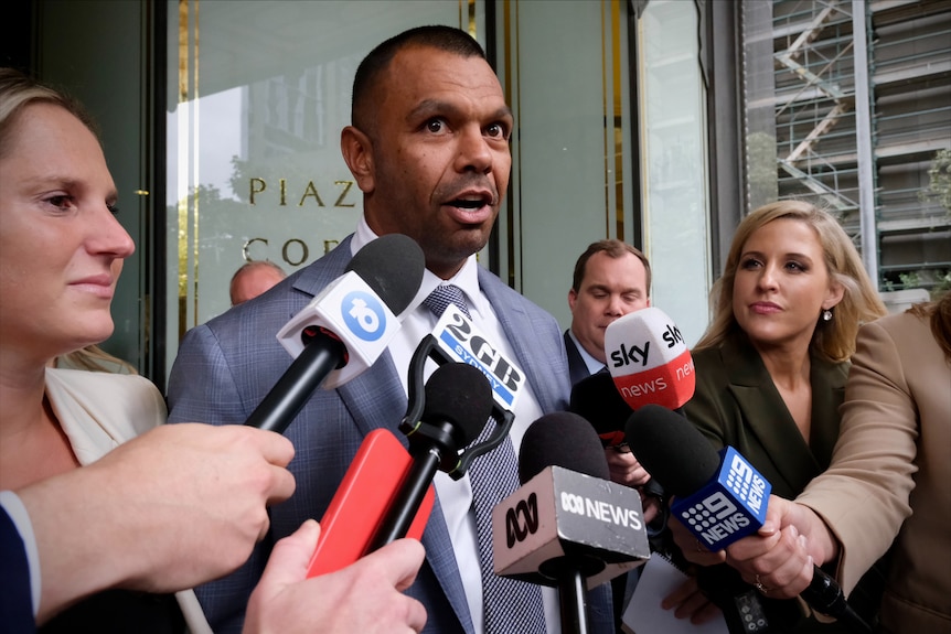 Kurtley Beale dressed in a suit and addresses the media after the verdict
