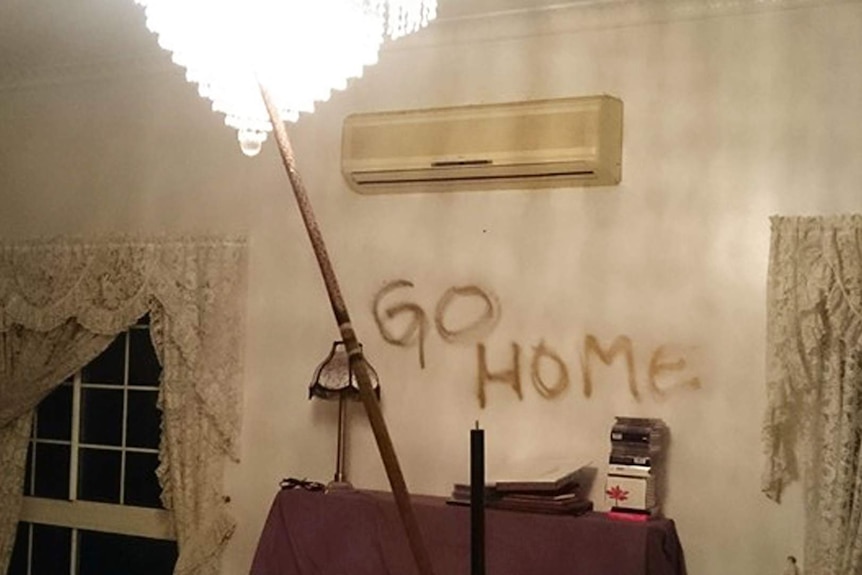 Racist slogan graffitied on a mirror inside a home