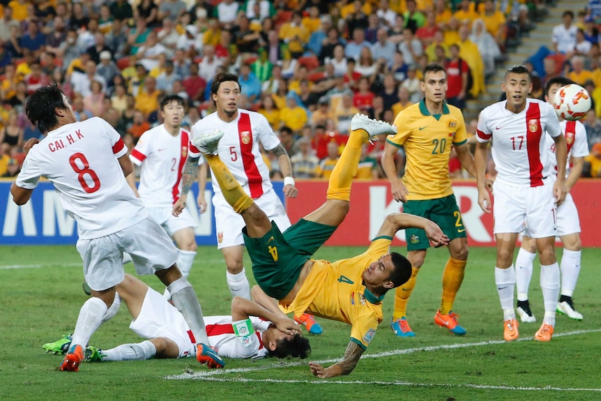Australia's Tim Cahill (C) scores a bicycle kick goal in the Asian Cup quarter-final against China.