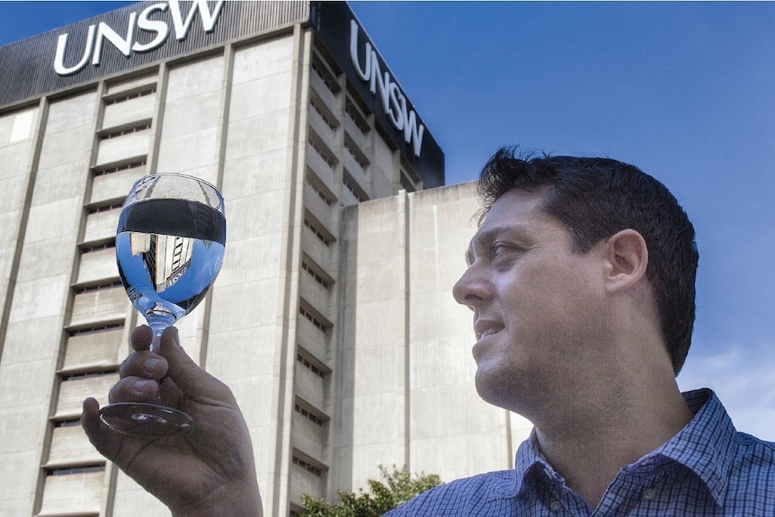 Professor Stuart Khan looks at a glass of water 