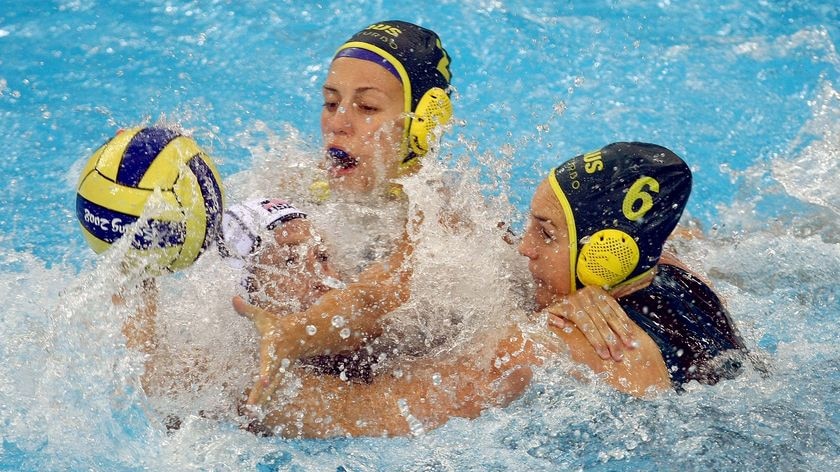 Australia's Bronwen Knox (6) and Gemma Beadsworth (2) fight for the ball against US centre Moriah Van Norman.