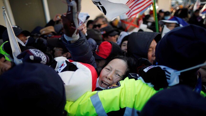 Police officers and protesters scuffle in South Korea.