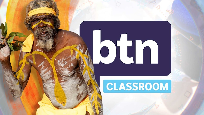 Indigenous man covered in body paint holds a bunch of eucalyptus leaves while performing a dance with the BTN logo behind.