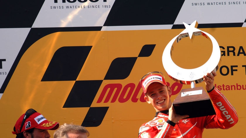 Casey Stoner celebrates his triumph