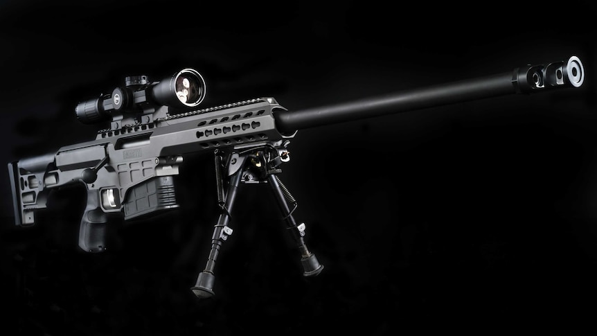 A large rifle against a black backdrop.