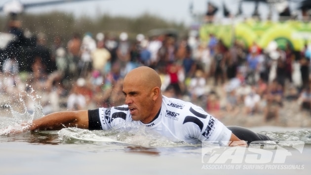 Slater paddles through the surf