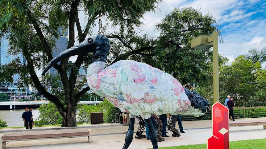 A large sculpture of an ibis made from waste material