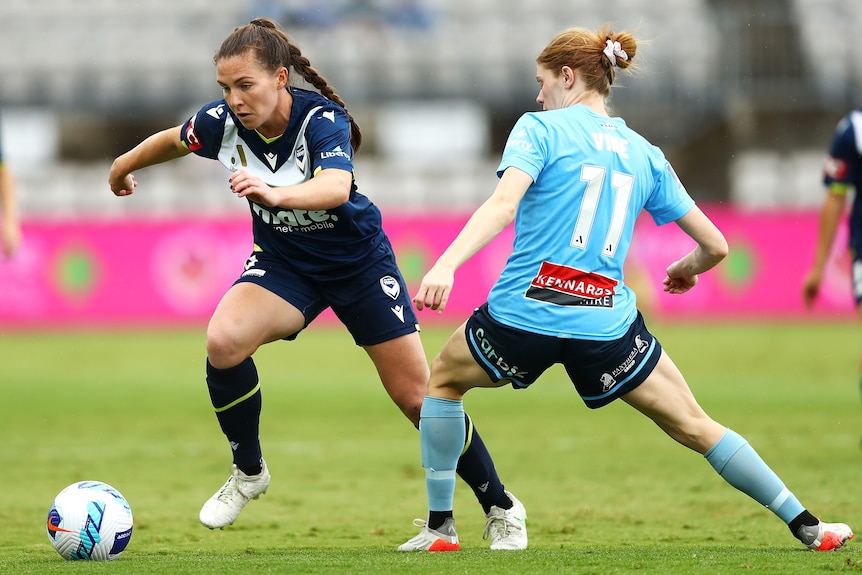 A Melbourne Victory A-League Women player tries to get past a Sydney FC opponent in the grand final.