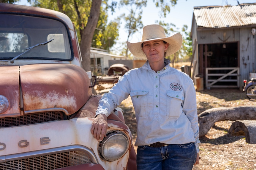 Jodie Muntelwit leans against a rusty ute.