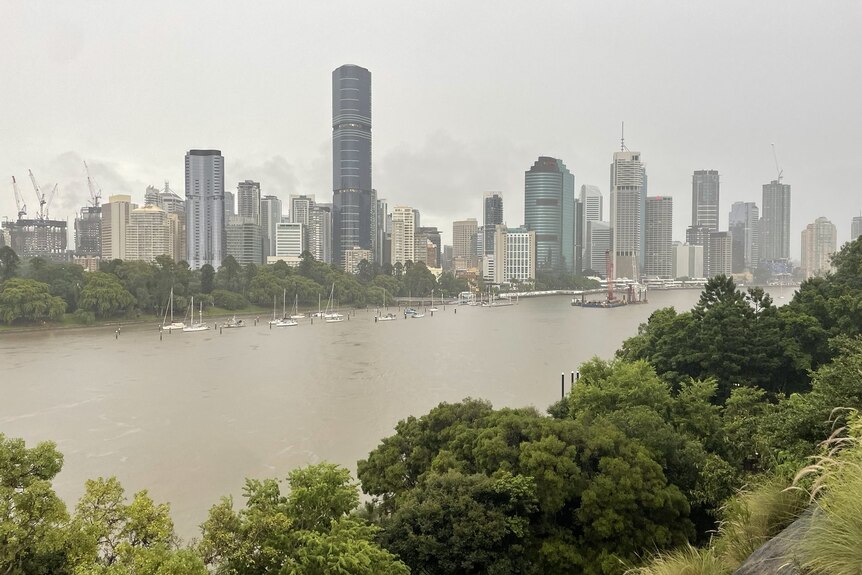 Rain falling over Brisbane CBD and river, in the foreground, taken from Kangaroo Point on February 23, 2022