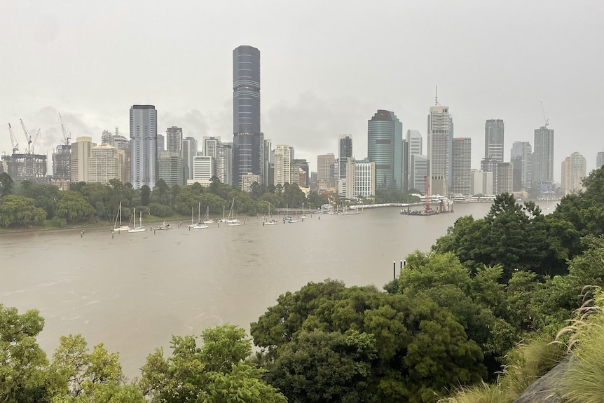 Rain falling over Brisbane CBD and river, in the foreground, taken from Kangaroo Point on February 23, 2022