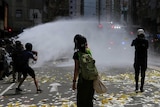 Riot police use a water cannon on anti-national security law protesters.