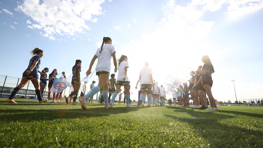 The teams head out during the A-League Women's round 19 match between Melbourne City and Newcastle Jets 