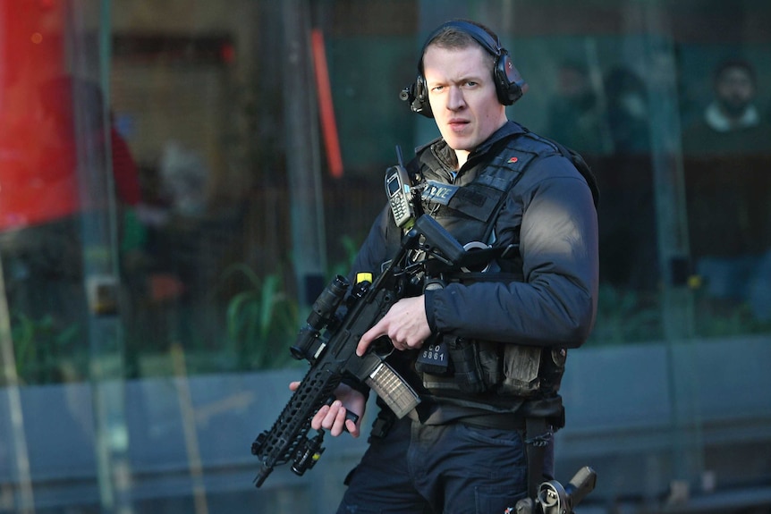 An armed police officer outside Borough Market after an incident on London Bridge.