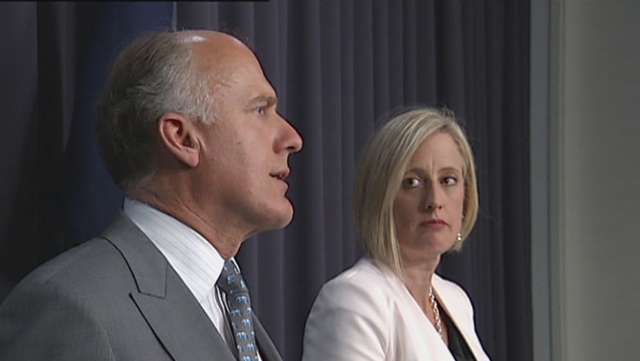 Katy Gallagher watches Eric Abetz during a press conference about the Mr Fluffy crisis in October 2014.
