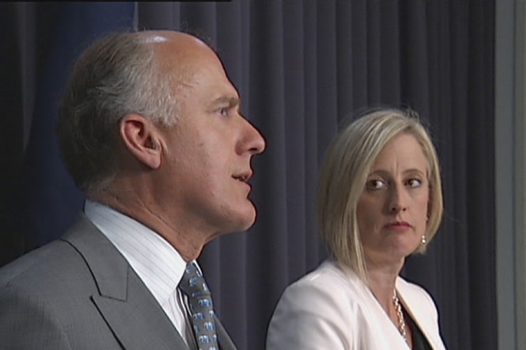 Katy Gallagher watches Eric Abetz during a press conference about the Mr Fluffy crisis in October 2014.