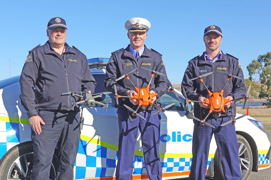Tasmania Police officers show off their new drones.