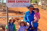 Lara Jensen with her three children in front of a Wondinong Station sign