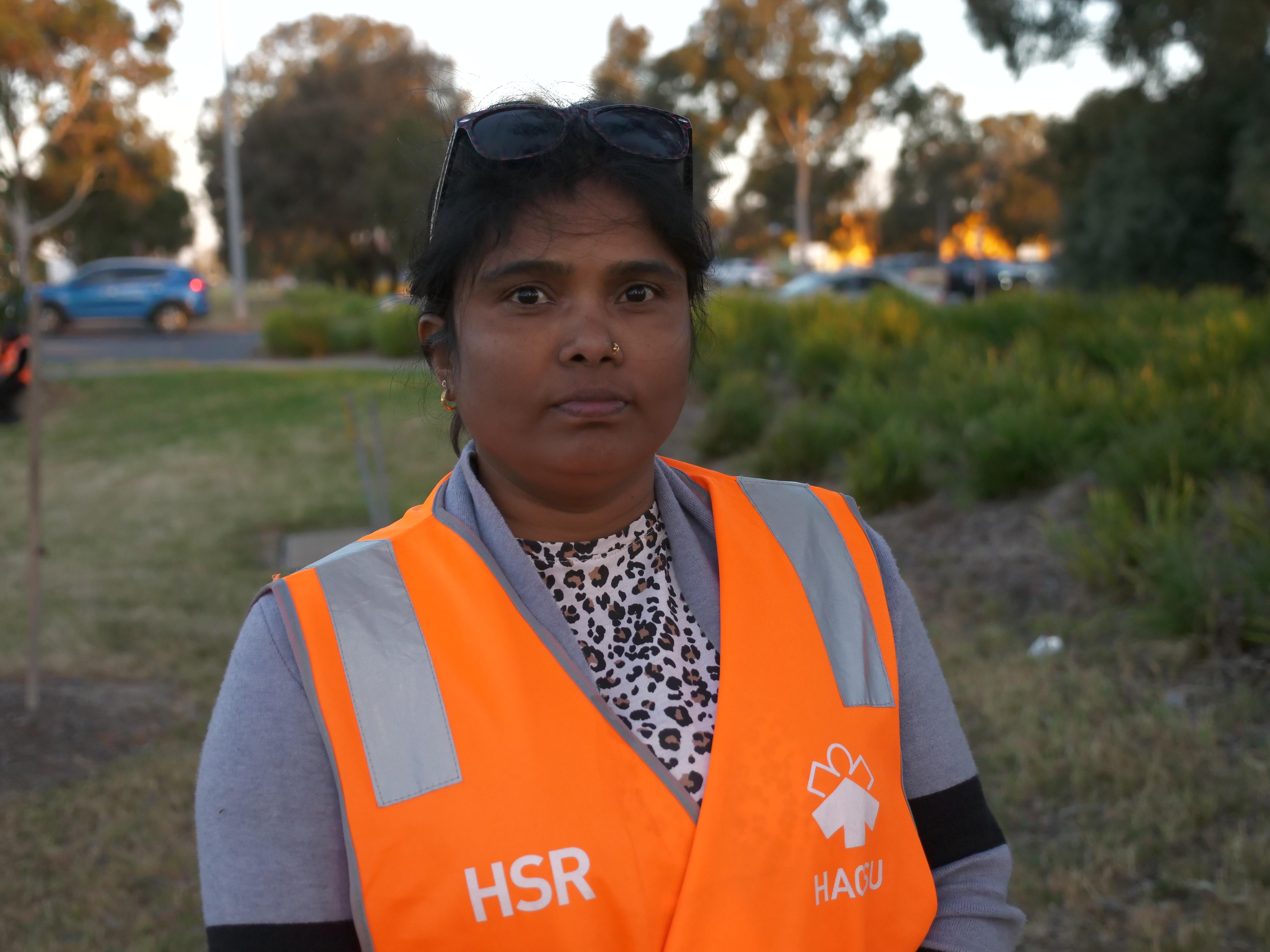 A women wearing an orange high vis jacket