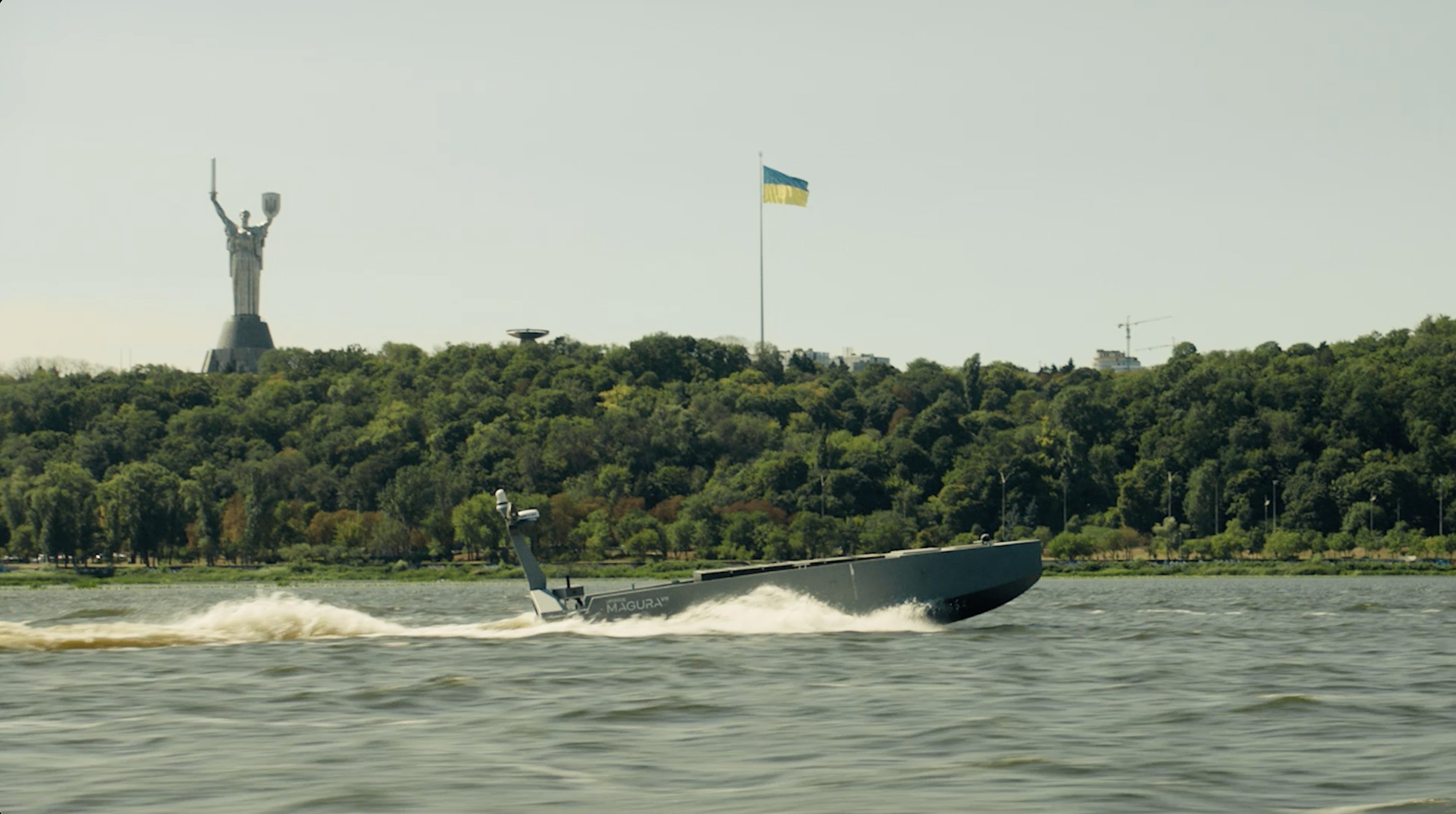 A drone boat powering along a river