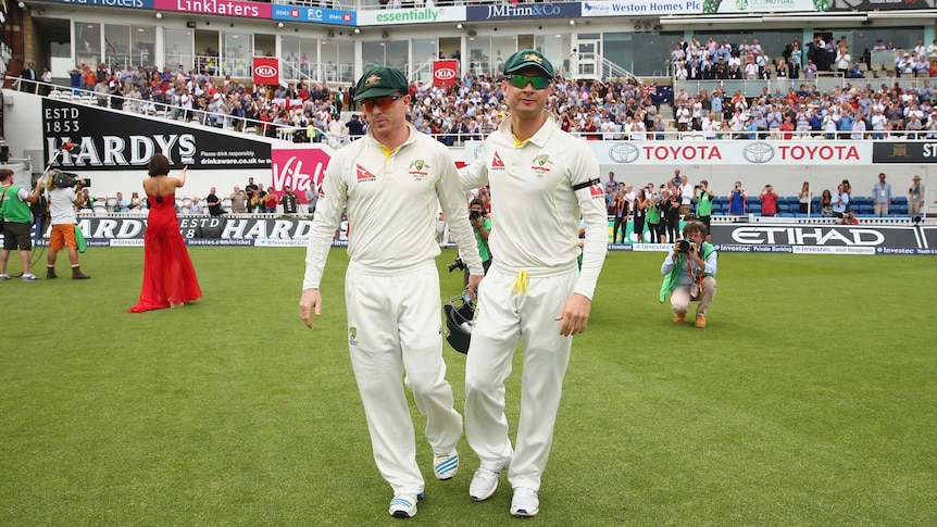Michael Clarke and Chris Rogers take to the field