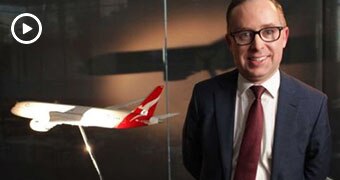 Qantas boss Alan Joyce in front of a model plane