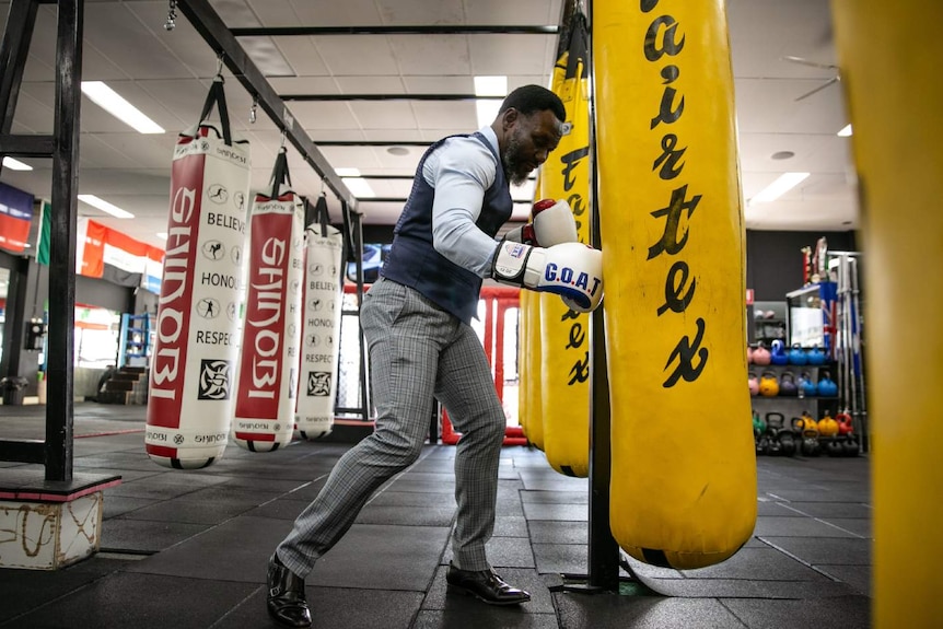 A man dressed in a suit boxing