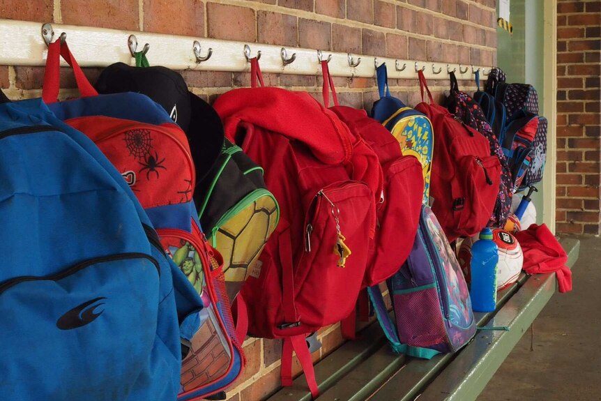 Backpacks hang on a wall at Yarloop Primary School.