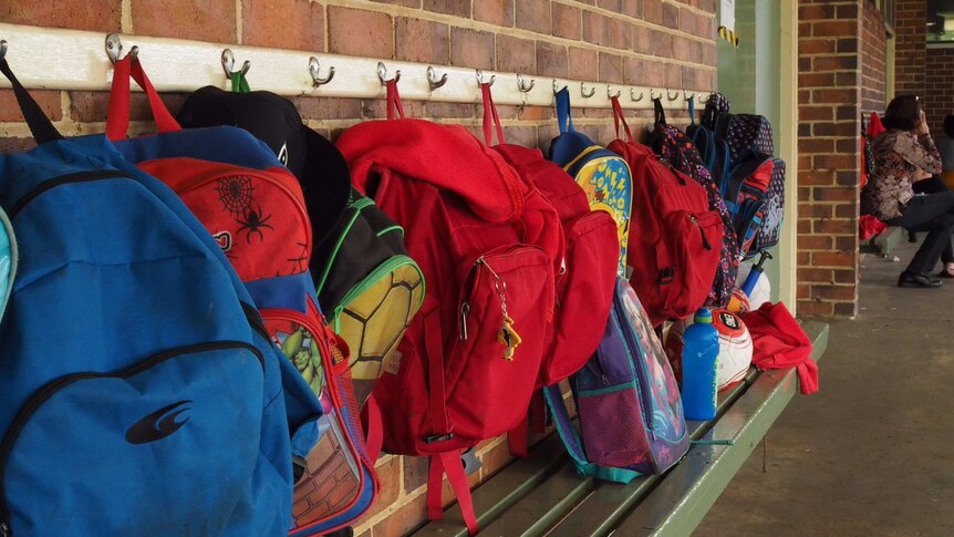Backpacks hang on a wall at Yarloop Primary School.