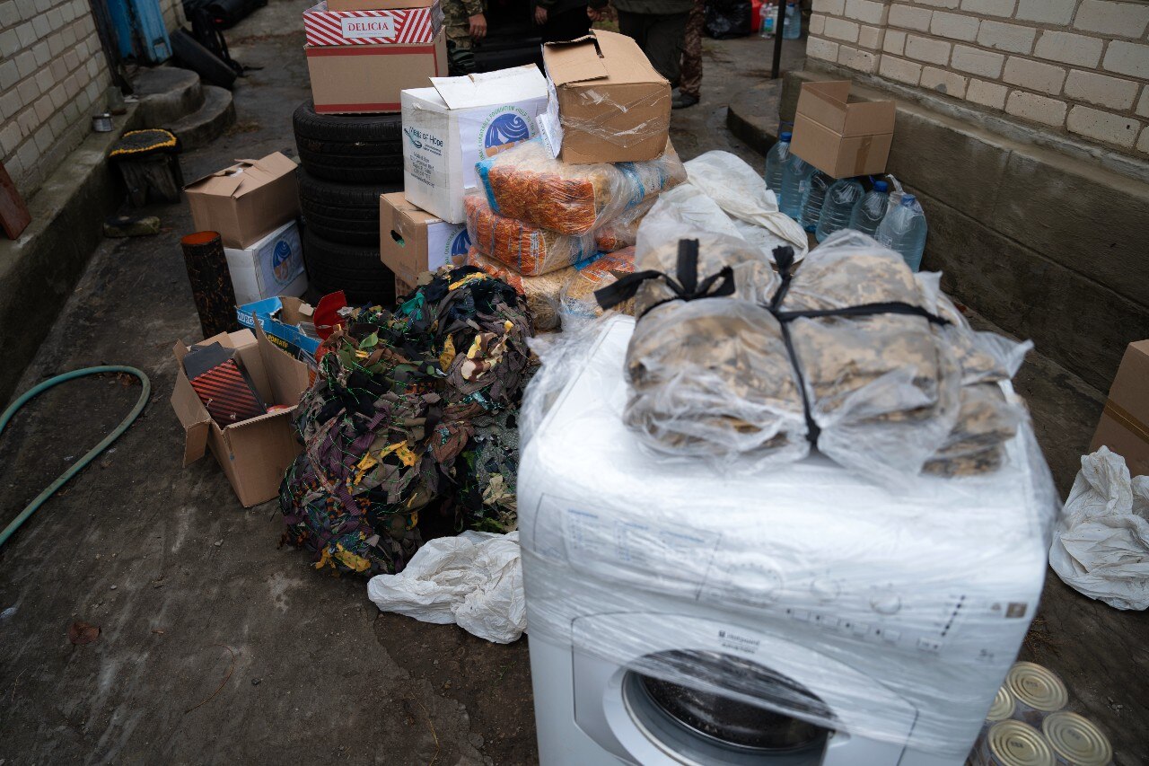 A large pile of boxes, and a washing machine