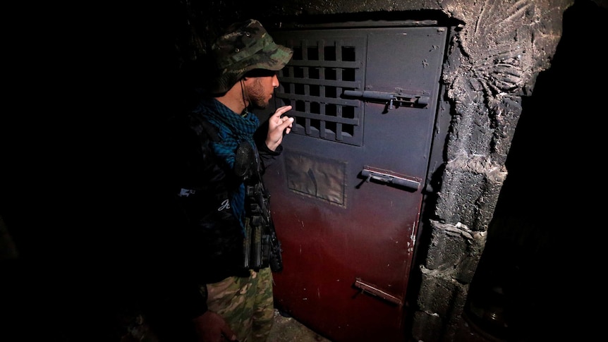 A member of Iraqi security forces inspects a building that was used as a prison by Islamic State militants.