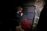 A member of Iraqi security forces inspects a building that was used as a prison by Islamic State militants.