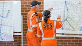 Victorian SES volunteers looking at a map of Melbourne. 