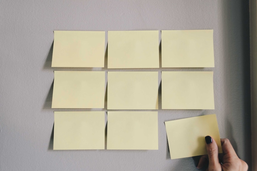 Nine blank yellow post-it notes