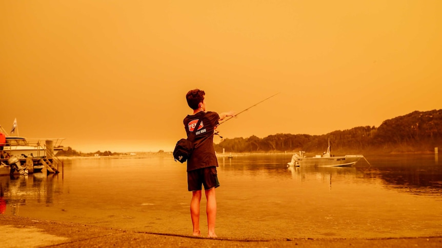 Child fishing on the shores in Narooma