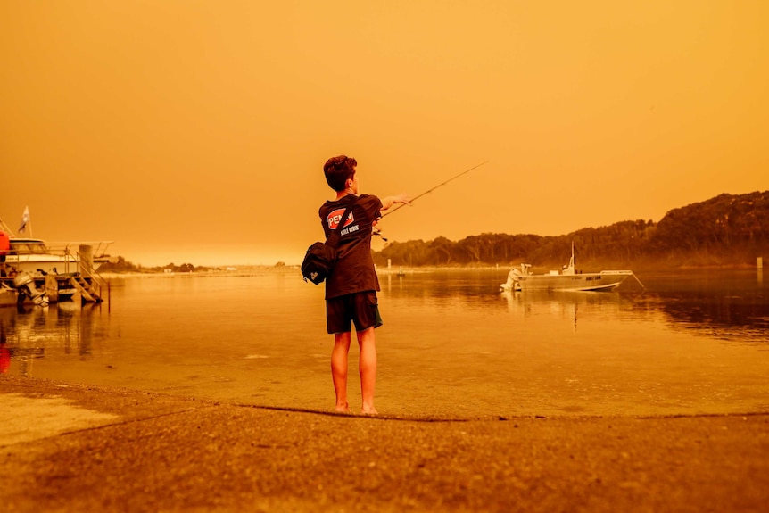 Child fishing on the shores in Narooma