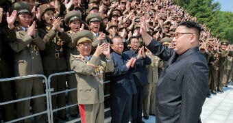 Kim Jong-un greets North Korean scientists.