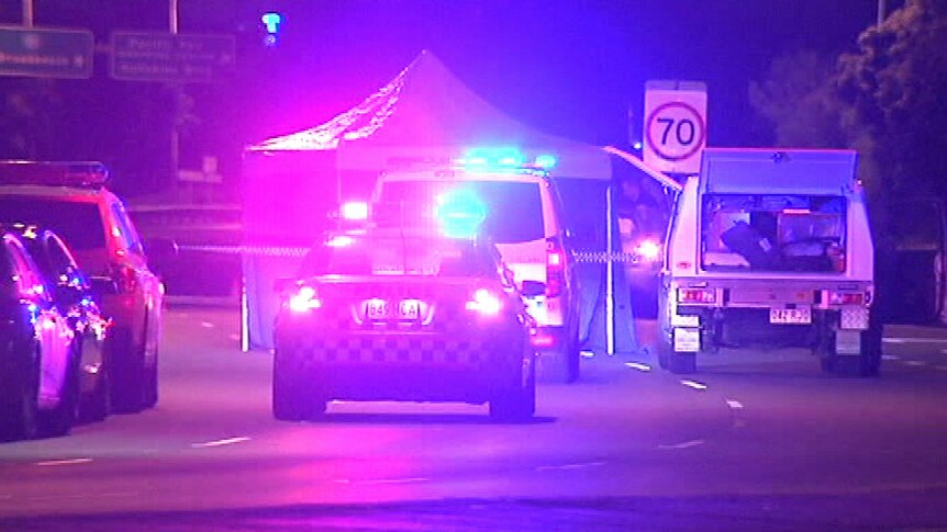 Police at the scene of a shooting murder of a man whose body was found on Hooker Boulevard at Broadbeach Waters.